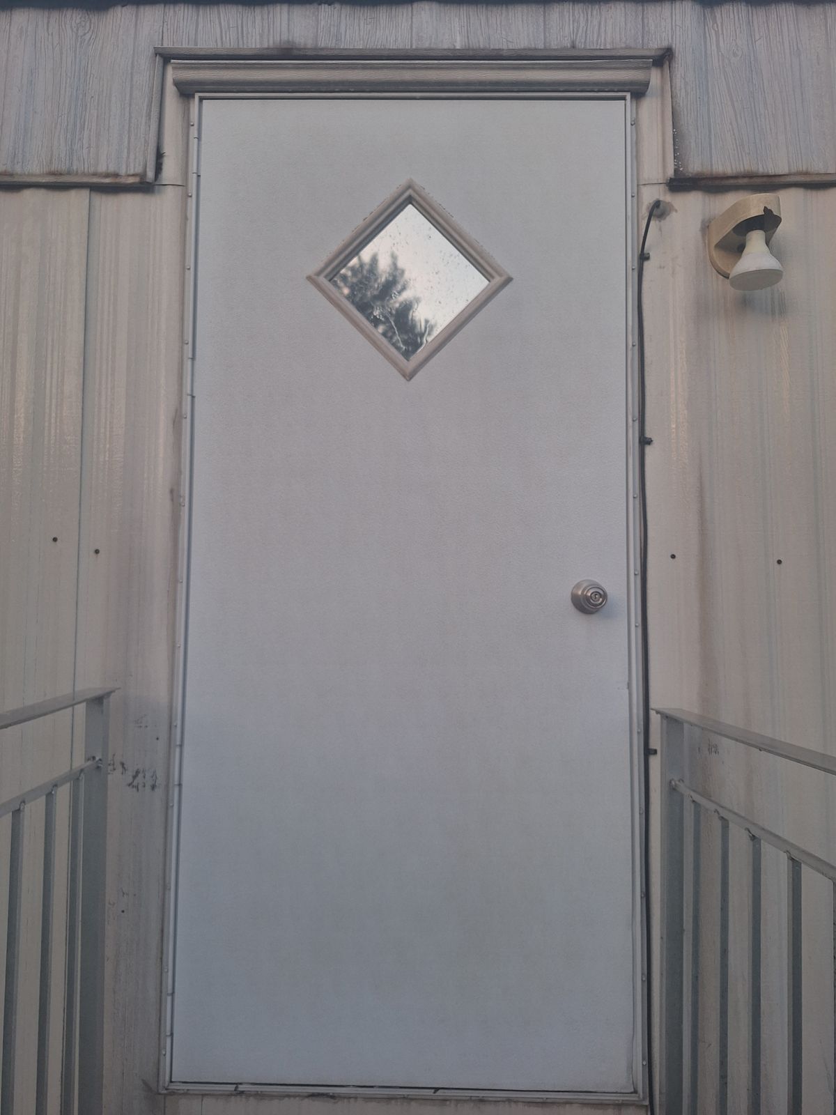 The same steel door, rust-free and uniformly clean, after rust removal